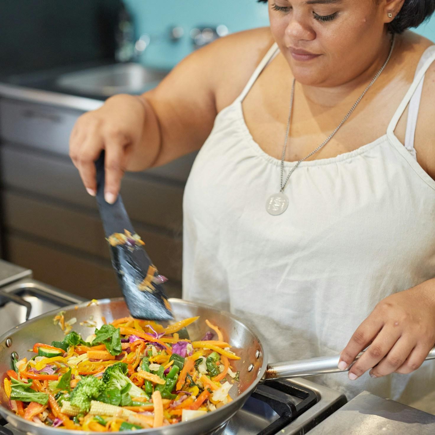 Community members collaborating in a modern kitchen space, sharing recipes and cooking techniques